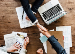 business people shaking hands together 53876 20488 uai